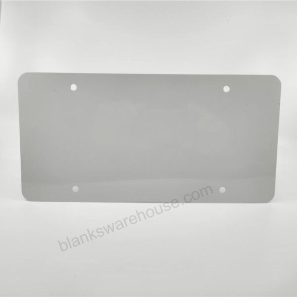 A license plate shaped aluminum plate with four holes