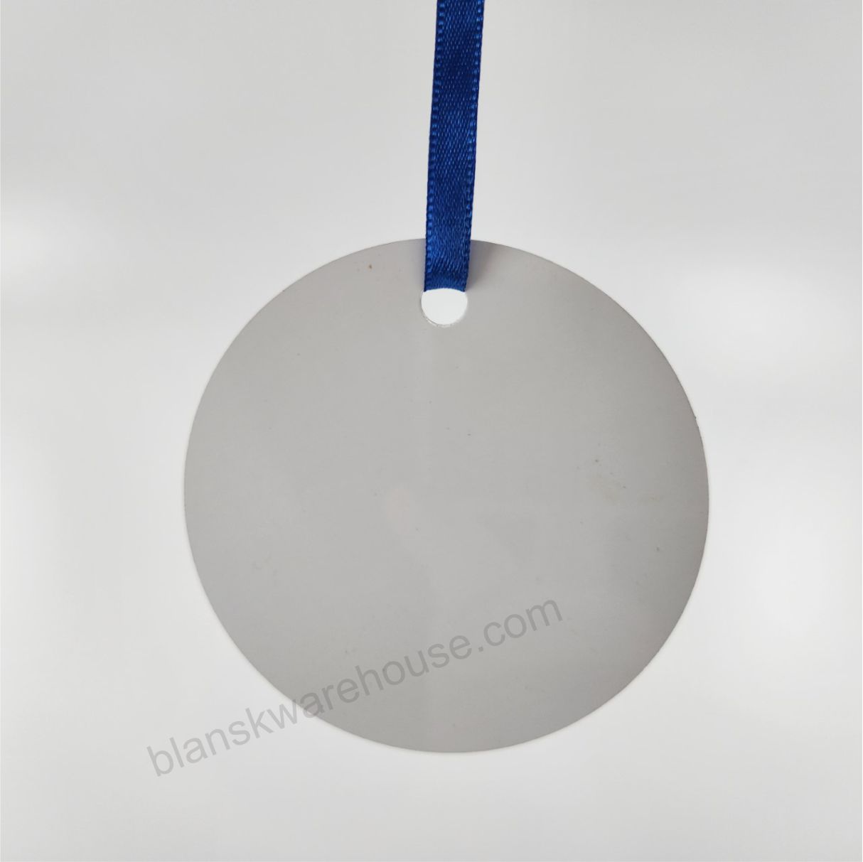 A circle shaped aluminum plate with one hole