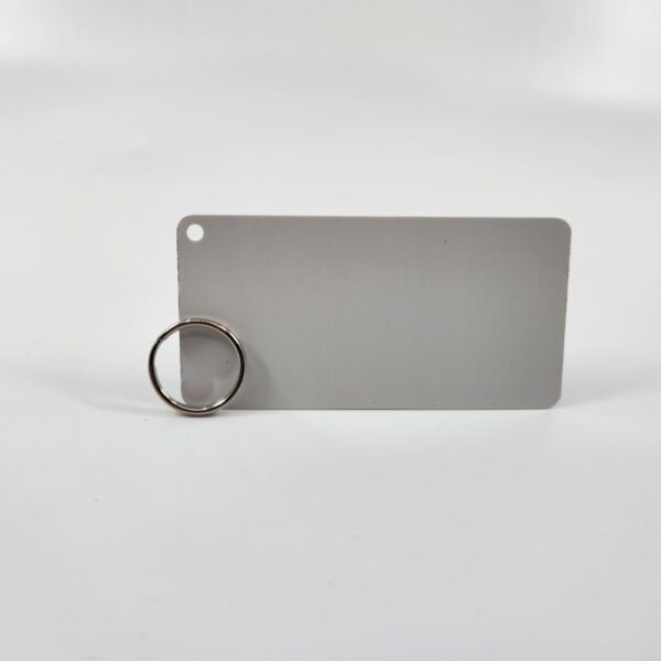 A keychain shaped aluminum plate with two small holes